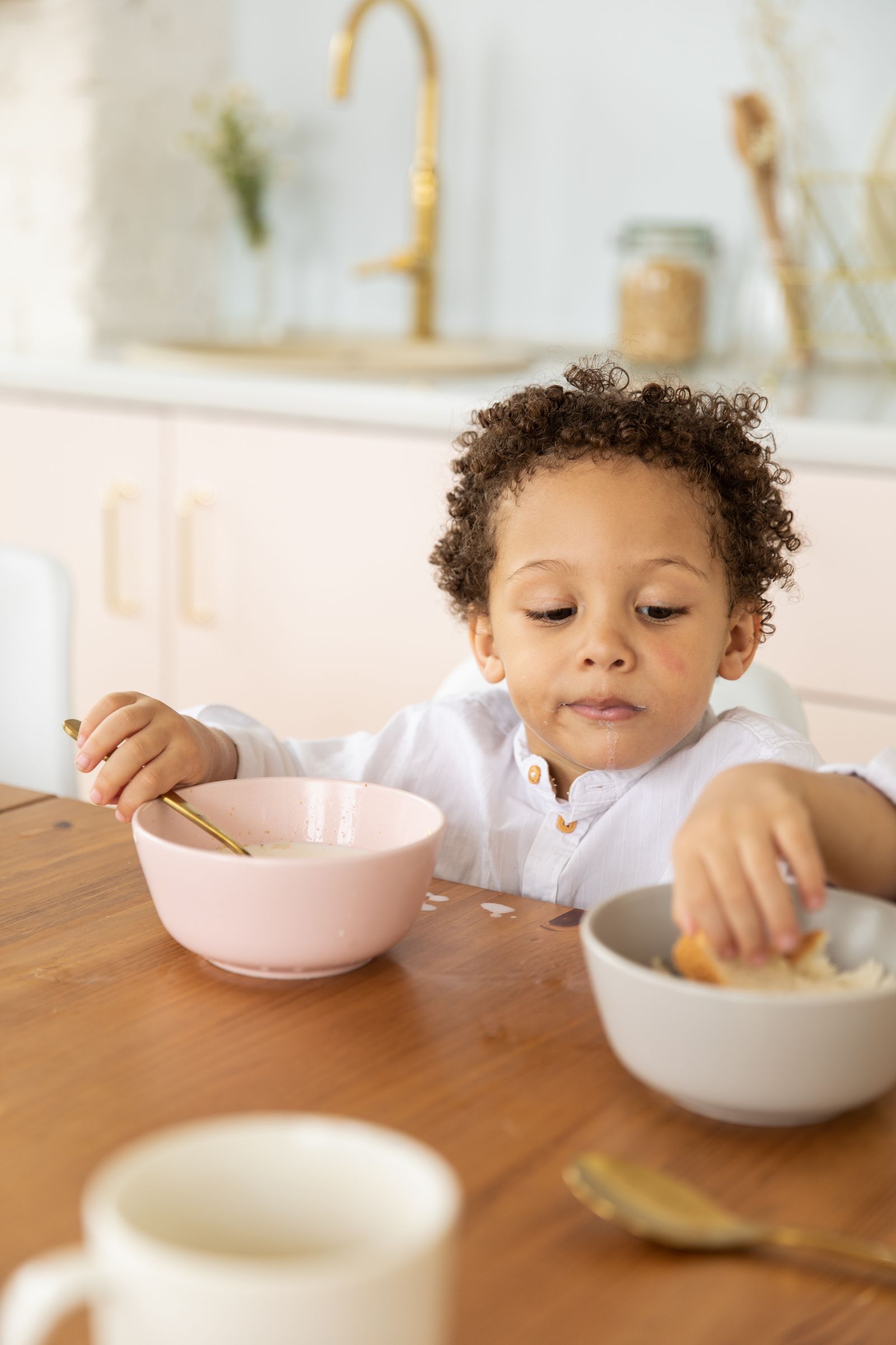A young child eating at a dining table
