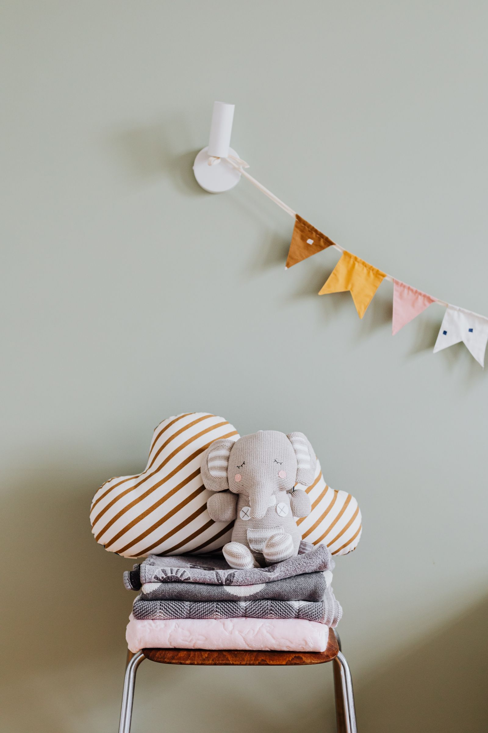 Folded blankets and pillows stored together for guest use