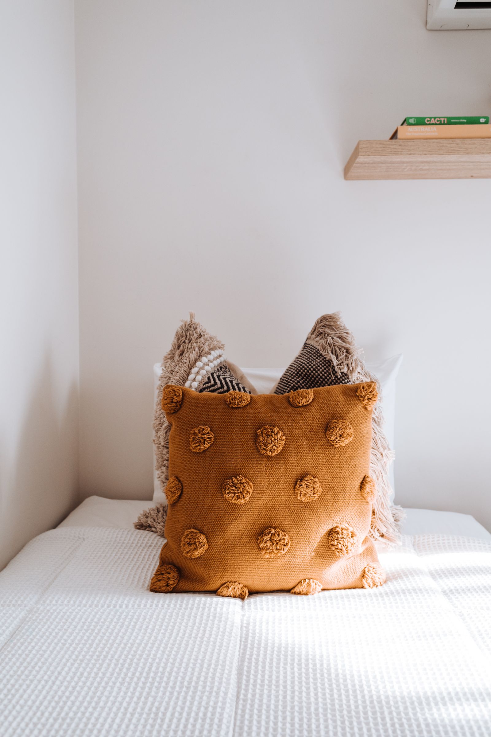 Pillows and white linens on a bed