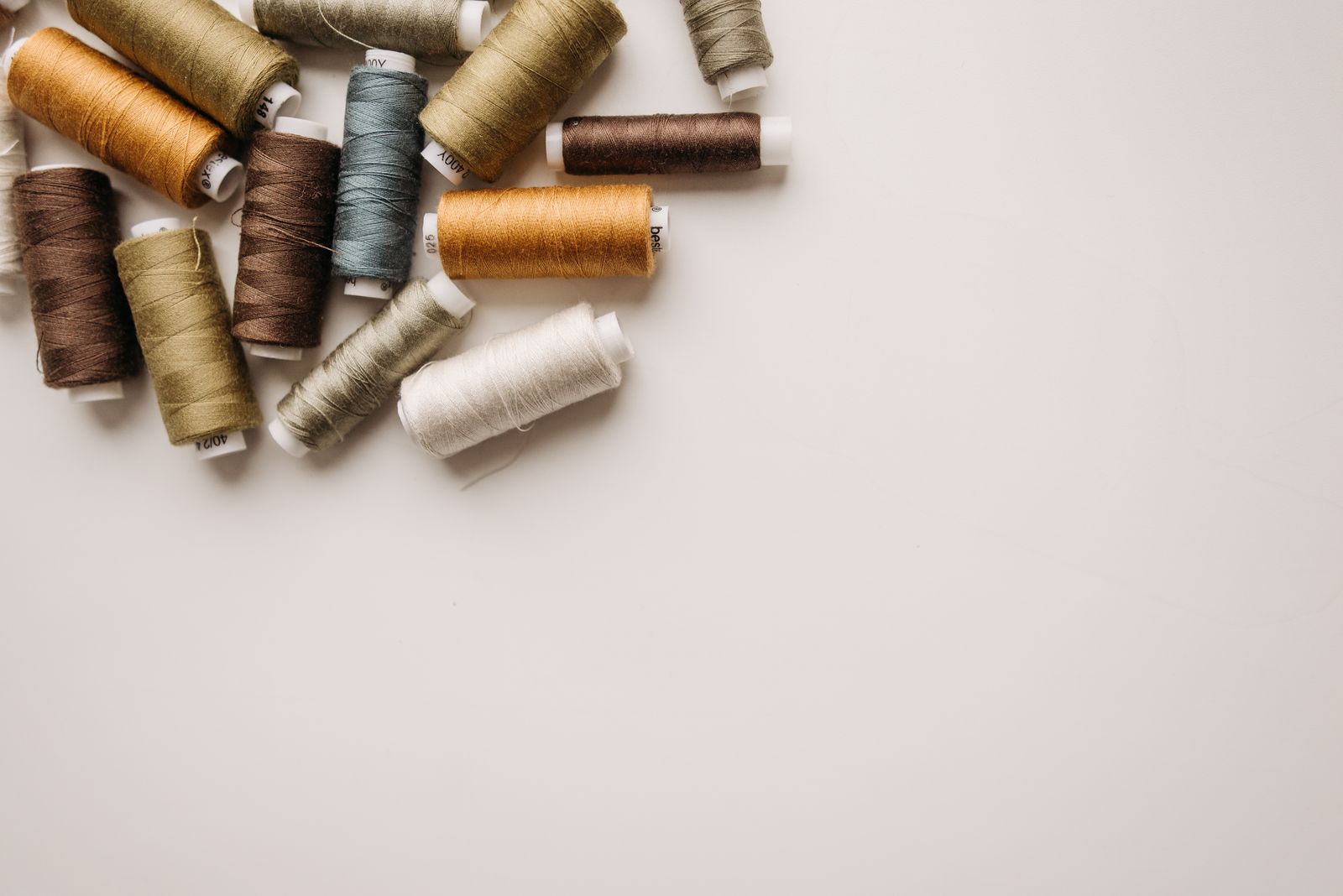 Small spools of thread in several neutral and muted colors