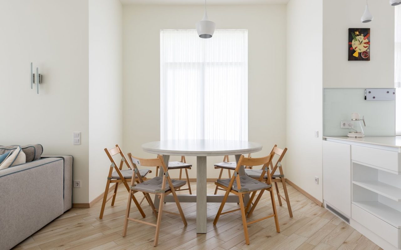 Round dining table with chairs in a compact apartment