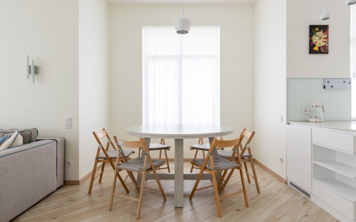 Round dining table with chairs in a compact apartment