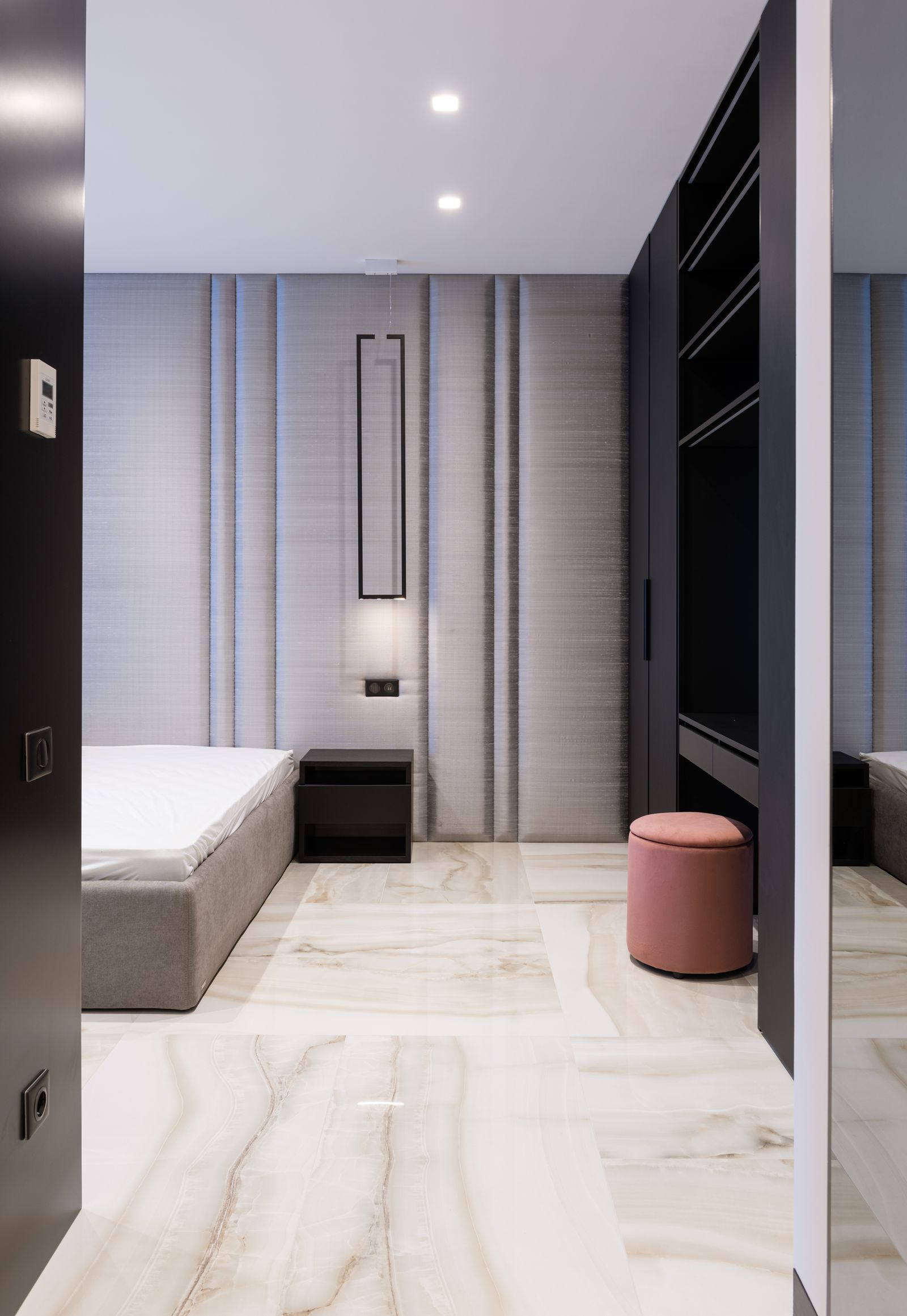 Bed positioned near compact storage furniture