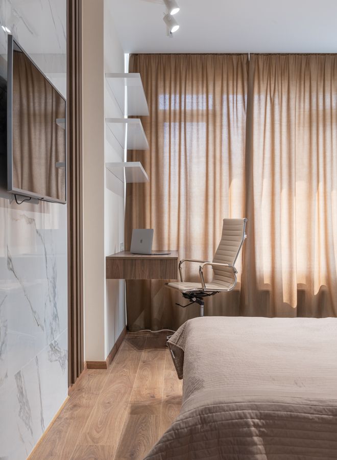 Compact bedroom with a dedicated workspace illustrating a room that changes between functions