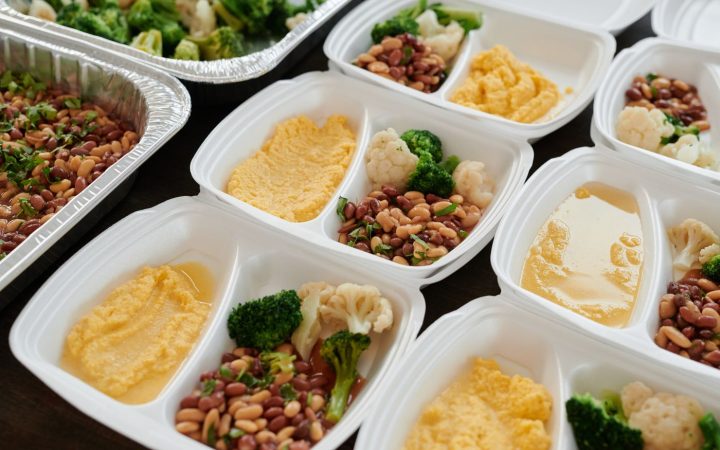 Assorted prepared foods portioned into storage containers