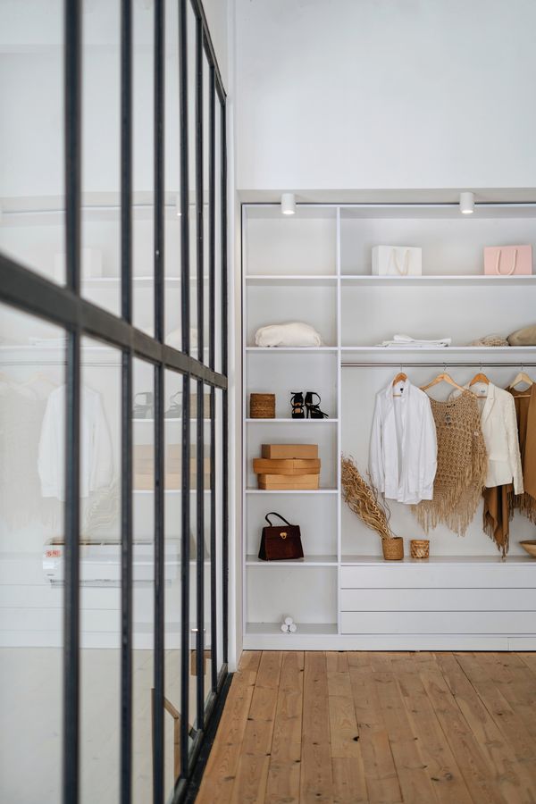 Modern apartment wardrobe with shelves and hanging storage making use of vertical space