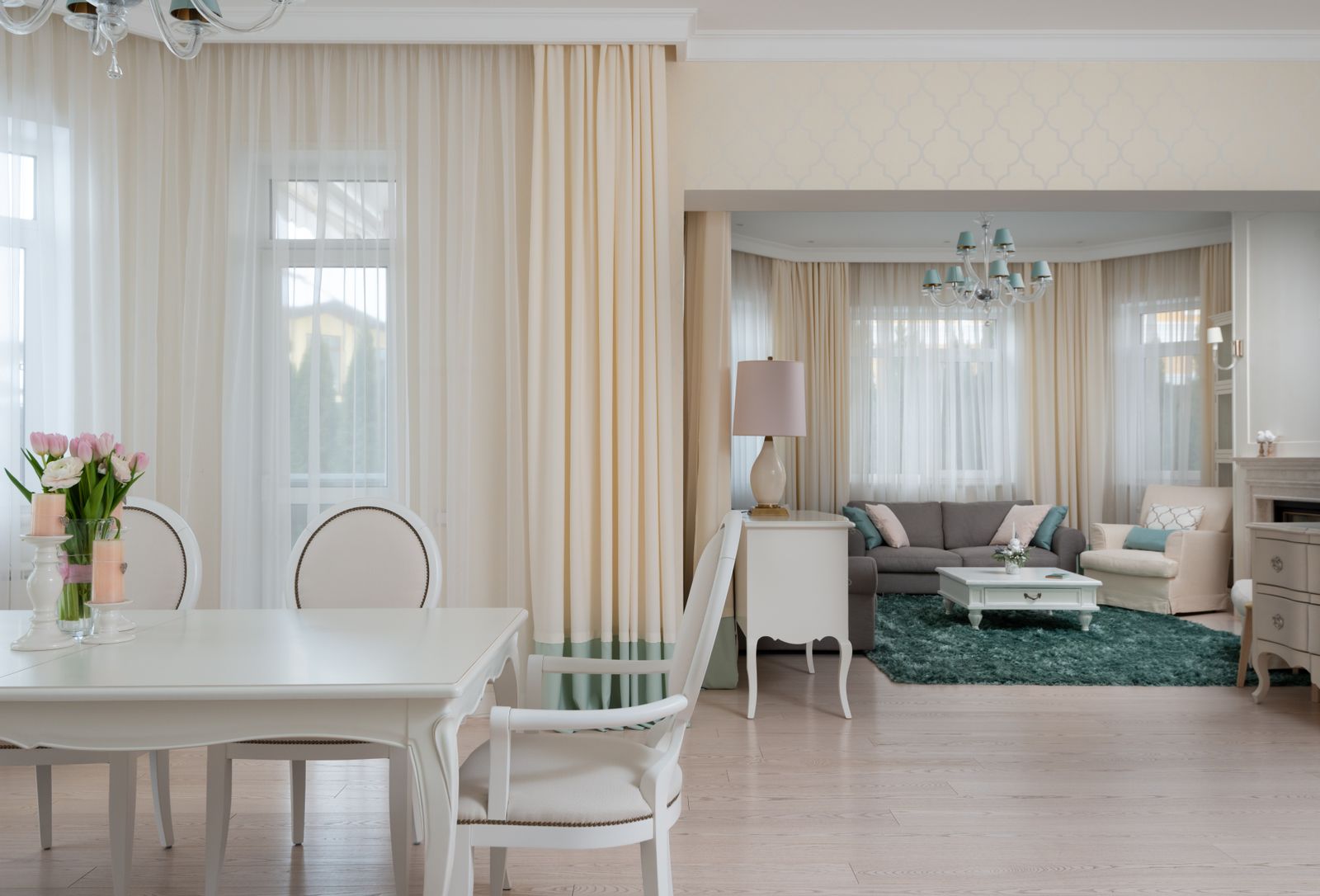 Dining table and chairs positioned within an open-plan home
