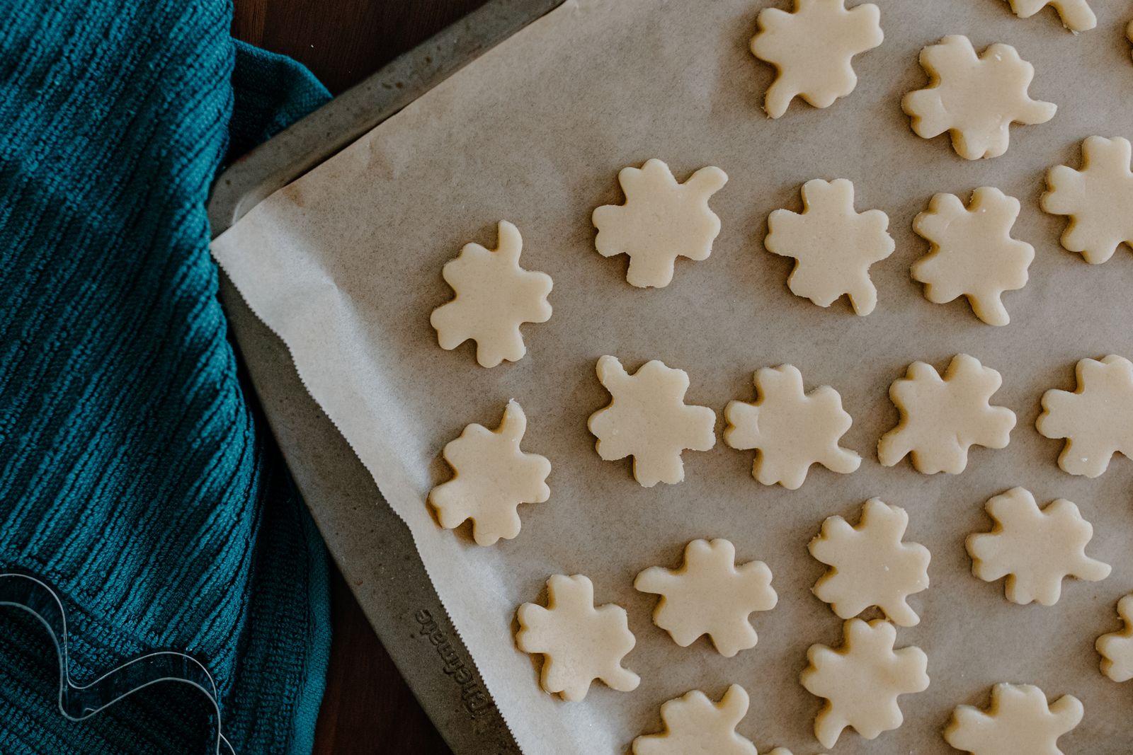 Unbaked shaped cookies on parchment paper