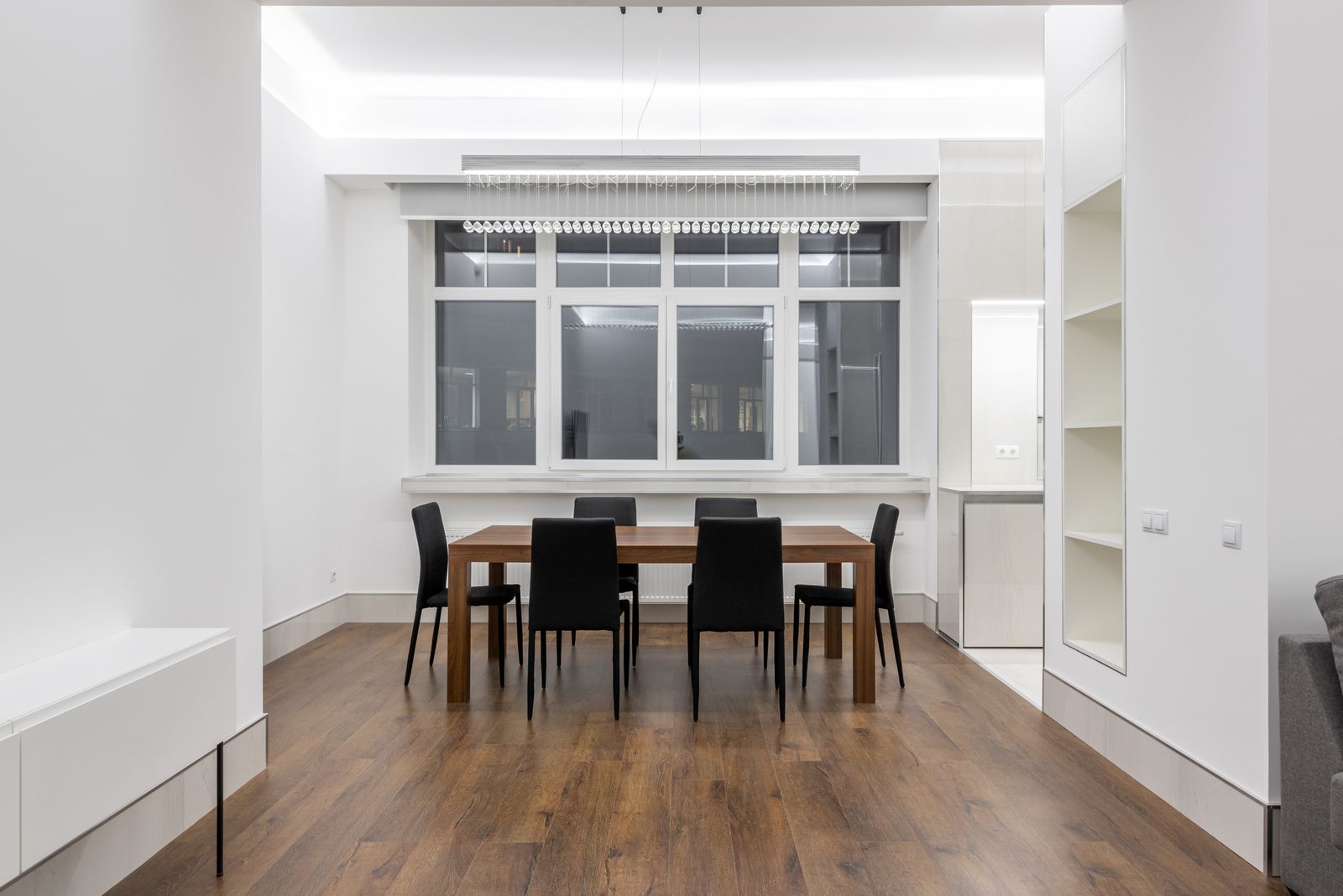 Wooden dining table and chairs with surrounding circulation space