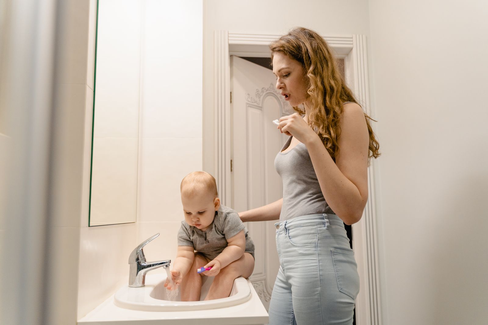 Mother and child brushing their teeth together