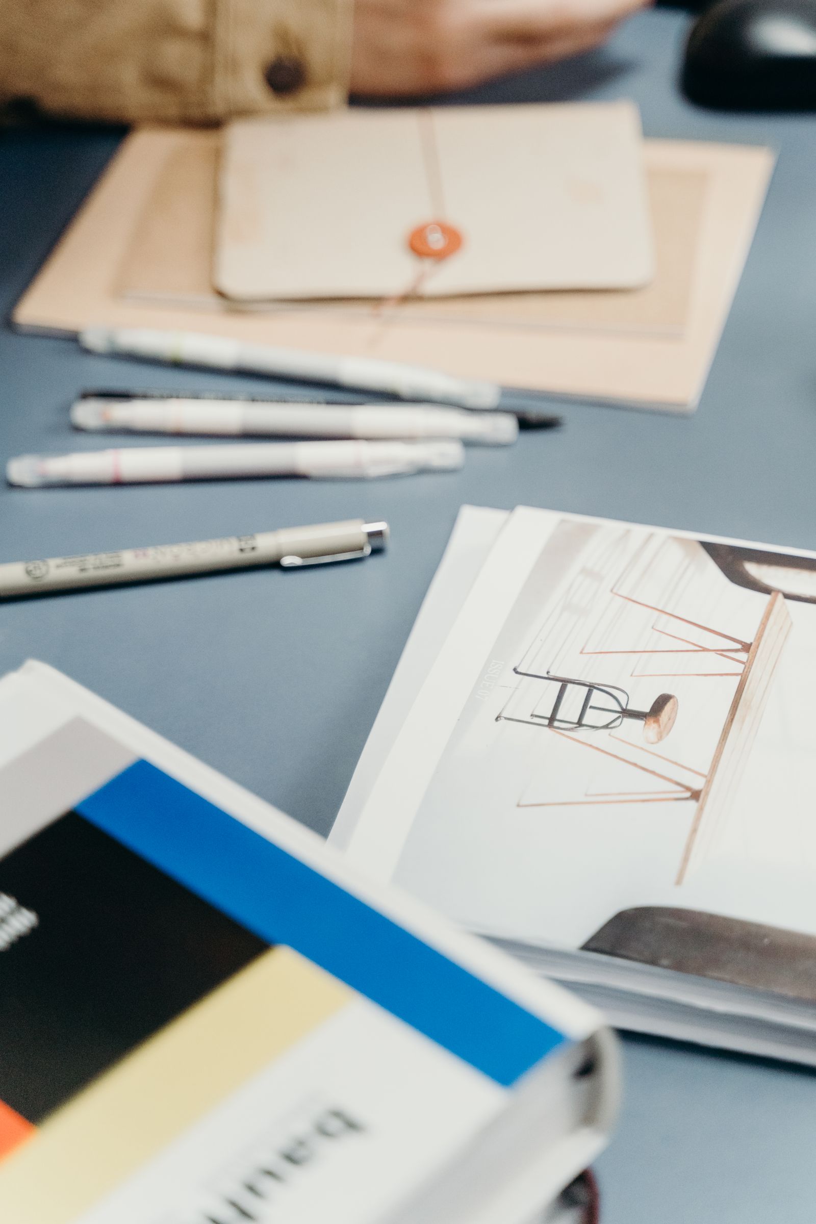 Stationery and paper arranged on a light-colored desk