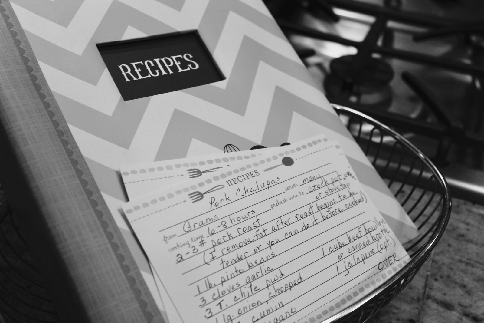 Handwritten recipe cards beside a recipe book