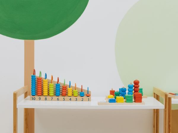Shelves with colorful toys arranged in visible categories for a simple active toy rotation