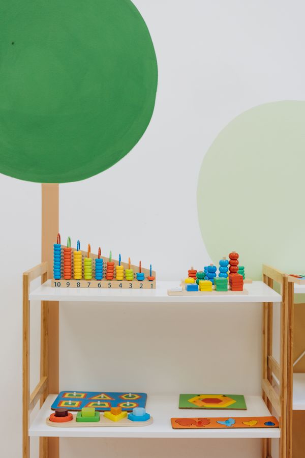 Shelves with colorful toys arranged in visible categories for a simple active toy rotation