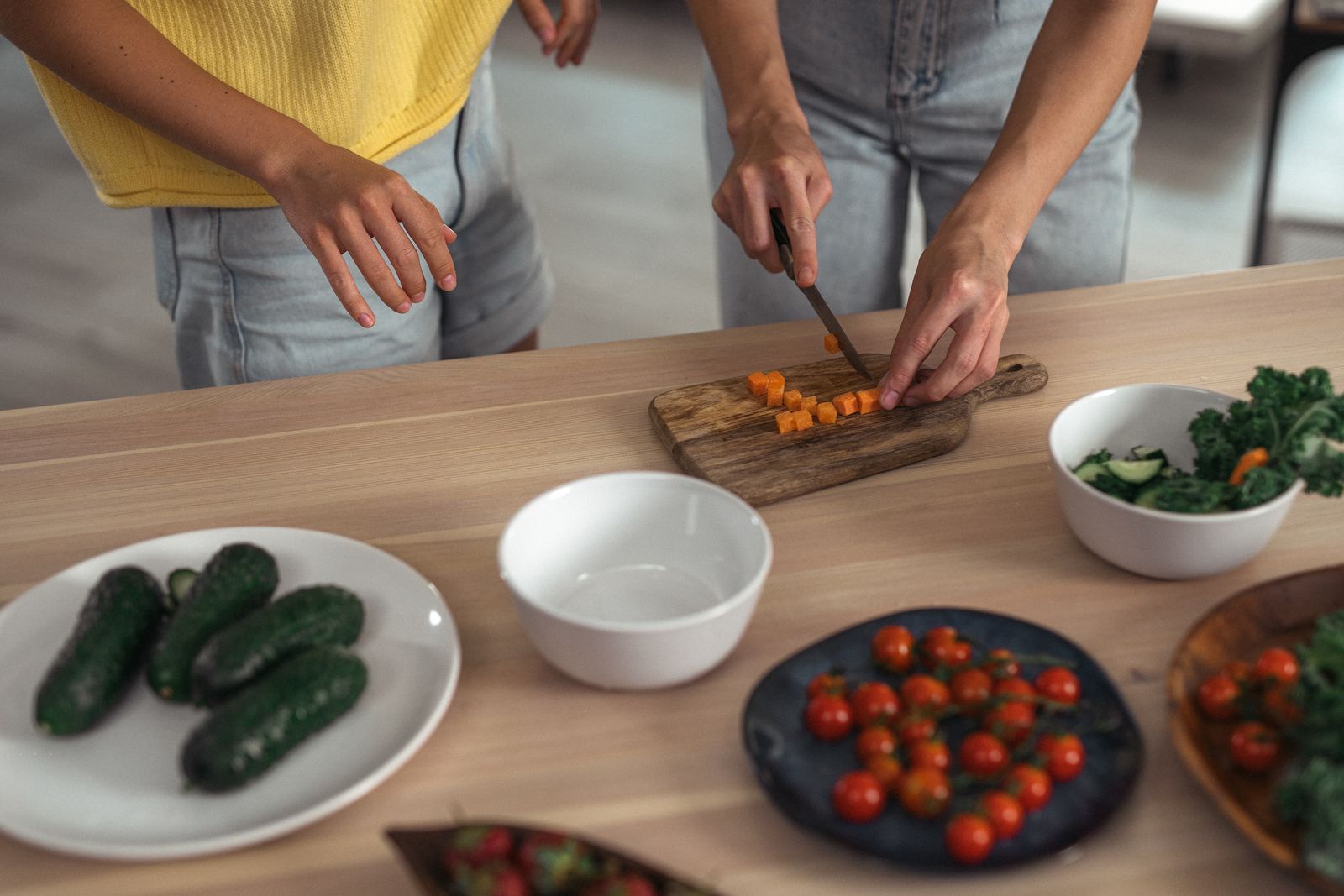 Carrots being chopped in a kitchen