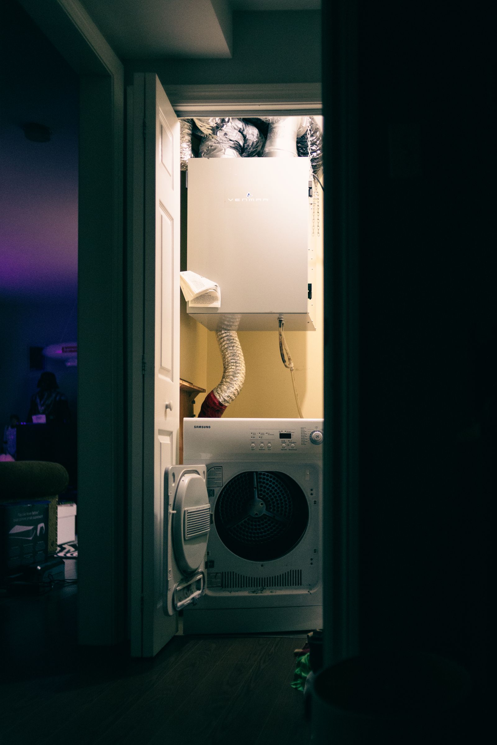 Front-load laundry appliance in a compact utility closet
