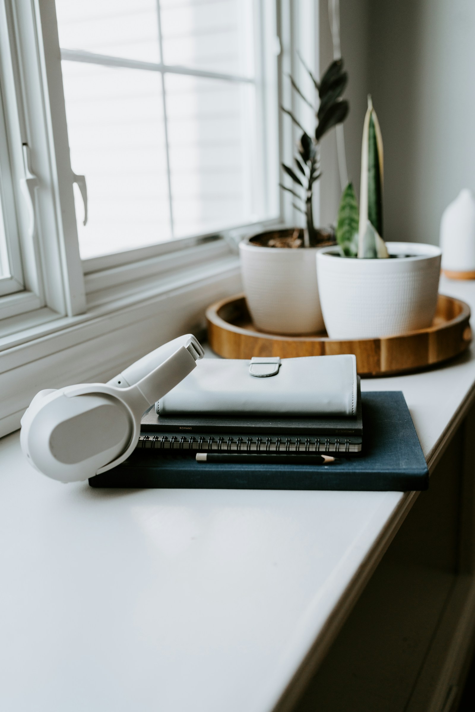 Reading and writing supplies beside a window
