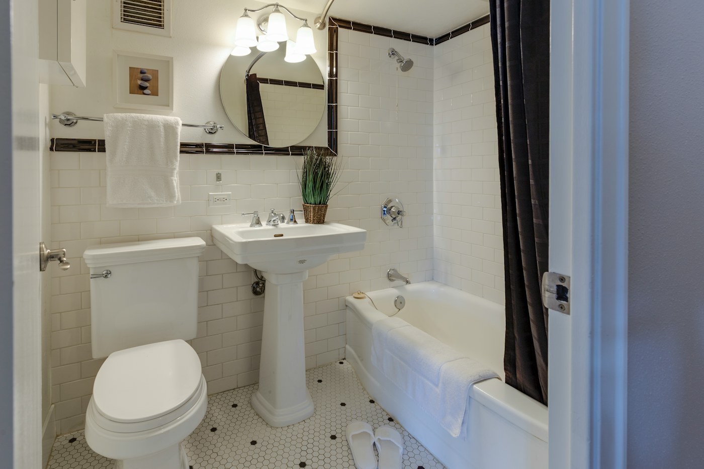 Small bathroom with clear surfaces and floor space supporting a simpler active set