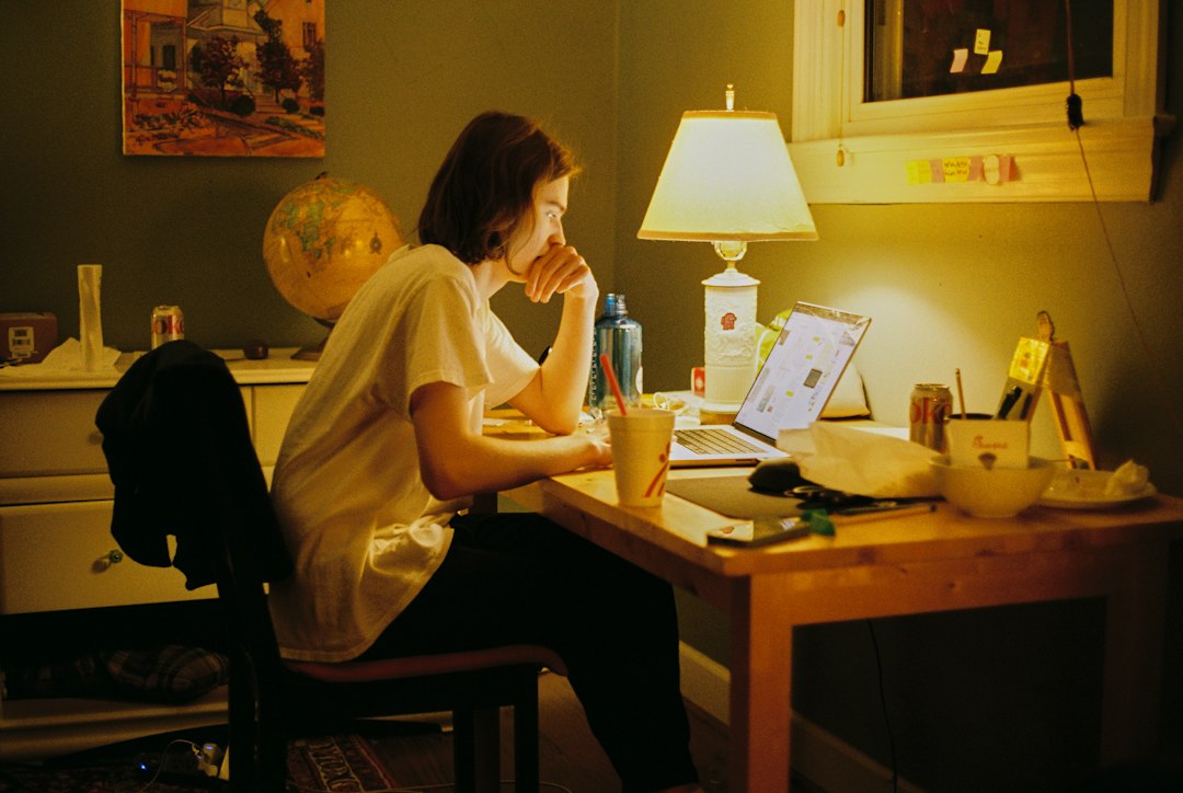 Adult using a computer at a small home desk