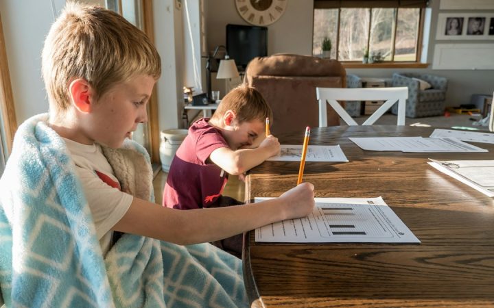 Child reading at a small table with space for school materials