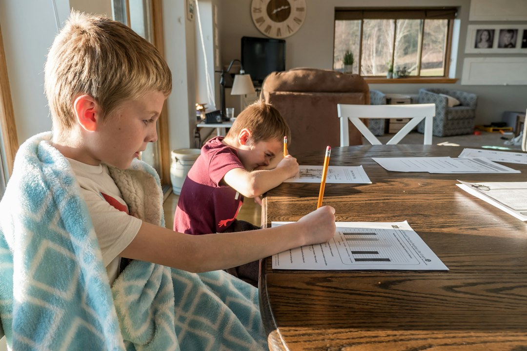 Child reading at a small table with space for school materials