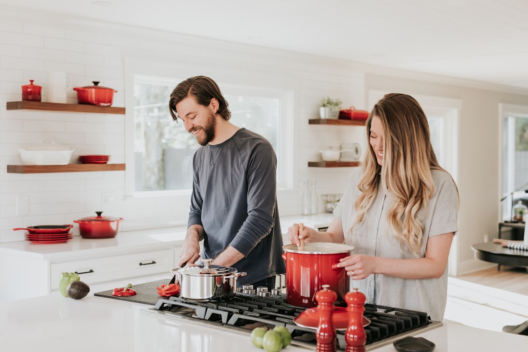 Adults working together in a kitchen during a home routine