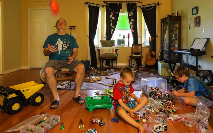 Toys spread across a family living-room floor before cleanup