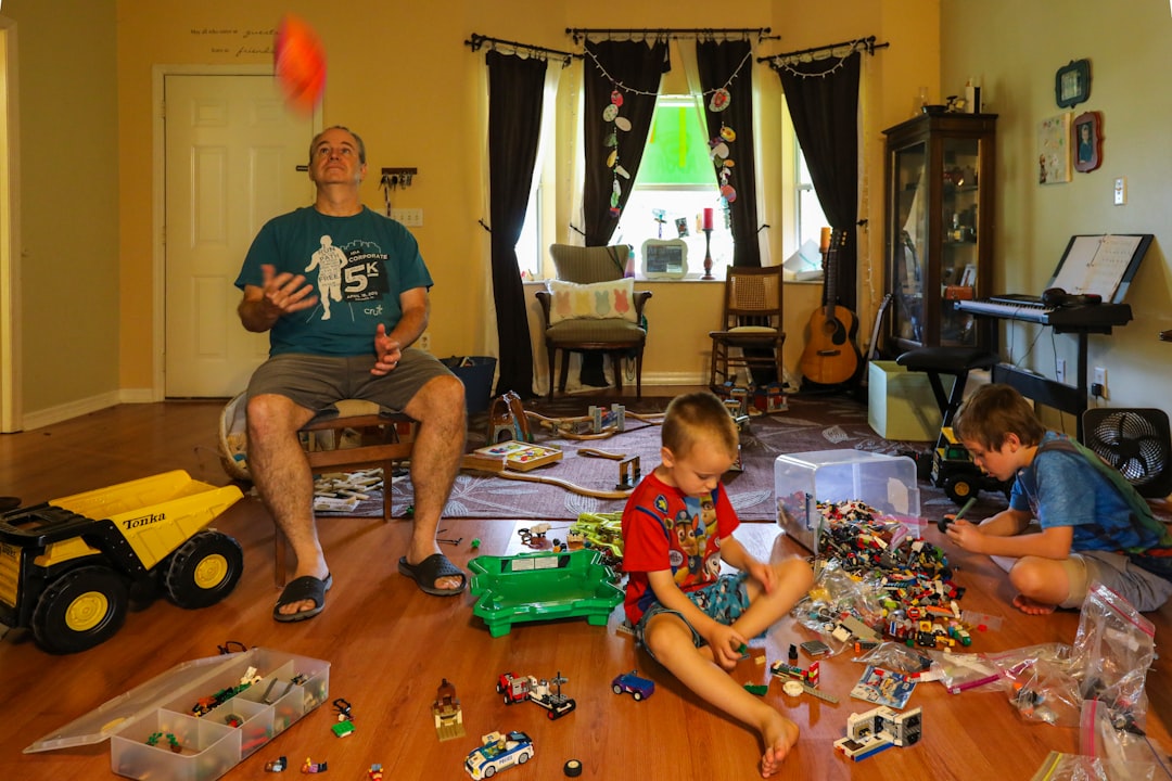 Toys spread across a family living-room floor before cleanup