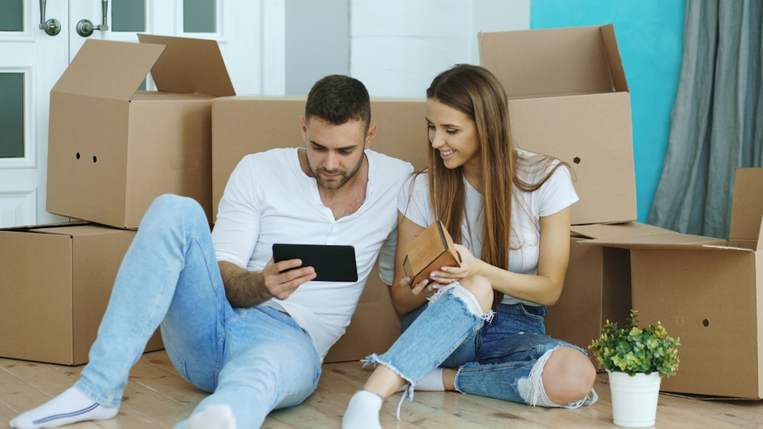Couple planning their new home while boxes remain to be unpacked
