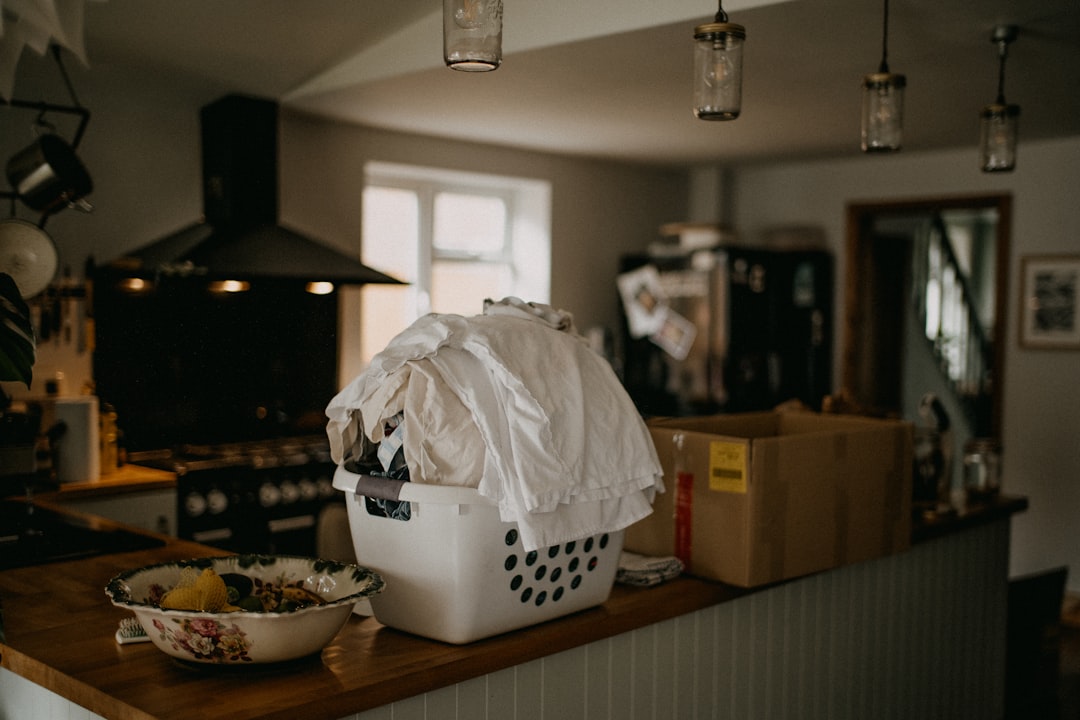 Laundry basket on a household surface, illustrating how temporary items can make a small home feel more cluttered