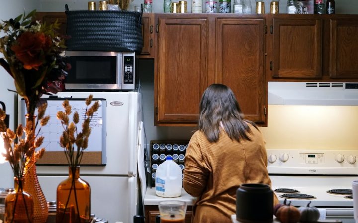 Person using a compact kitchen during a normal workweek routine