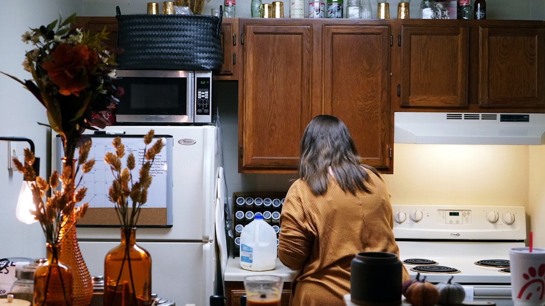 Person using a compact kitchen during a normal workweek routine