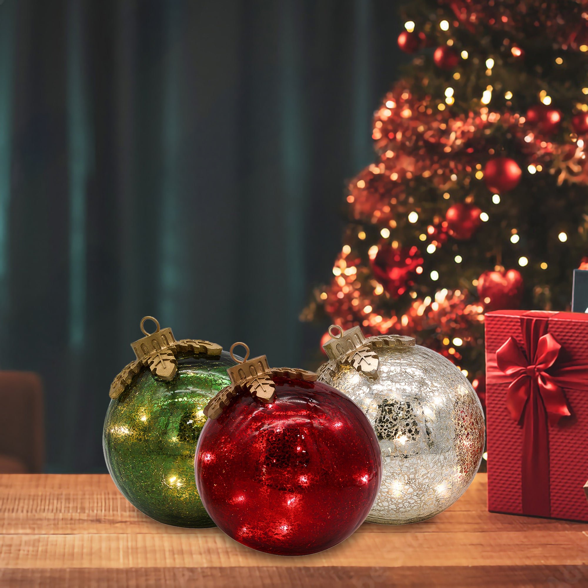 LumaBase glass ornament lights glowing beside a Christmas tree and wrapped gift