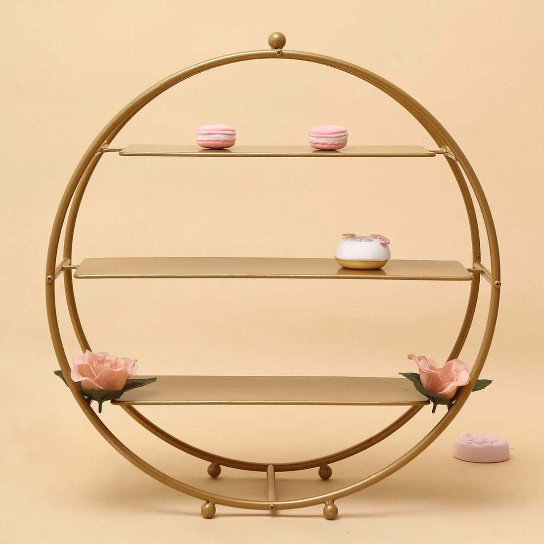Round wheel-shaped three-tier stand with separate styled desserts