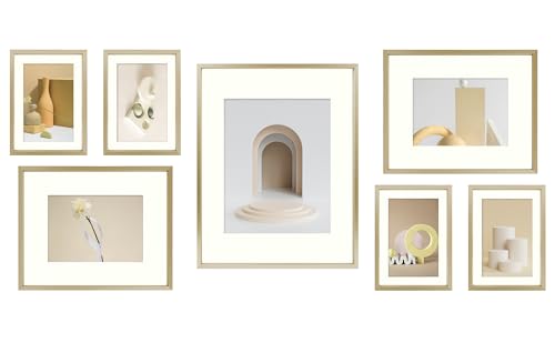 Seven gold Frametory frames arranged on a wall around a large central frame