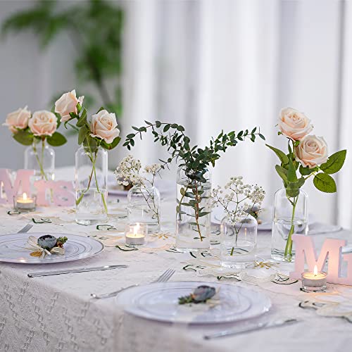HEWORY clear bud vases distributed across a dining table with separate flowers and tableware