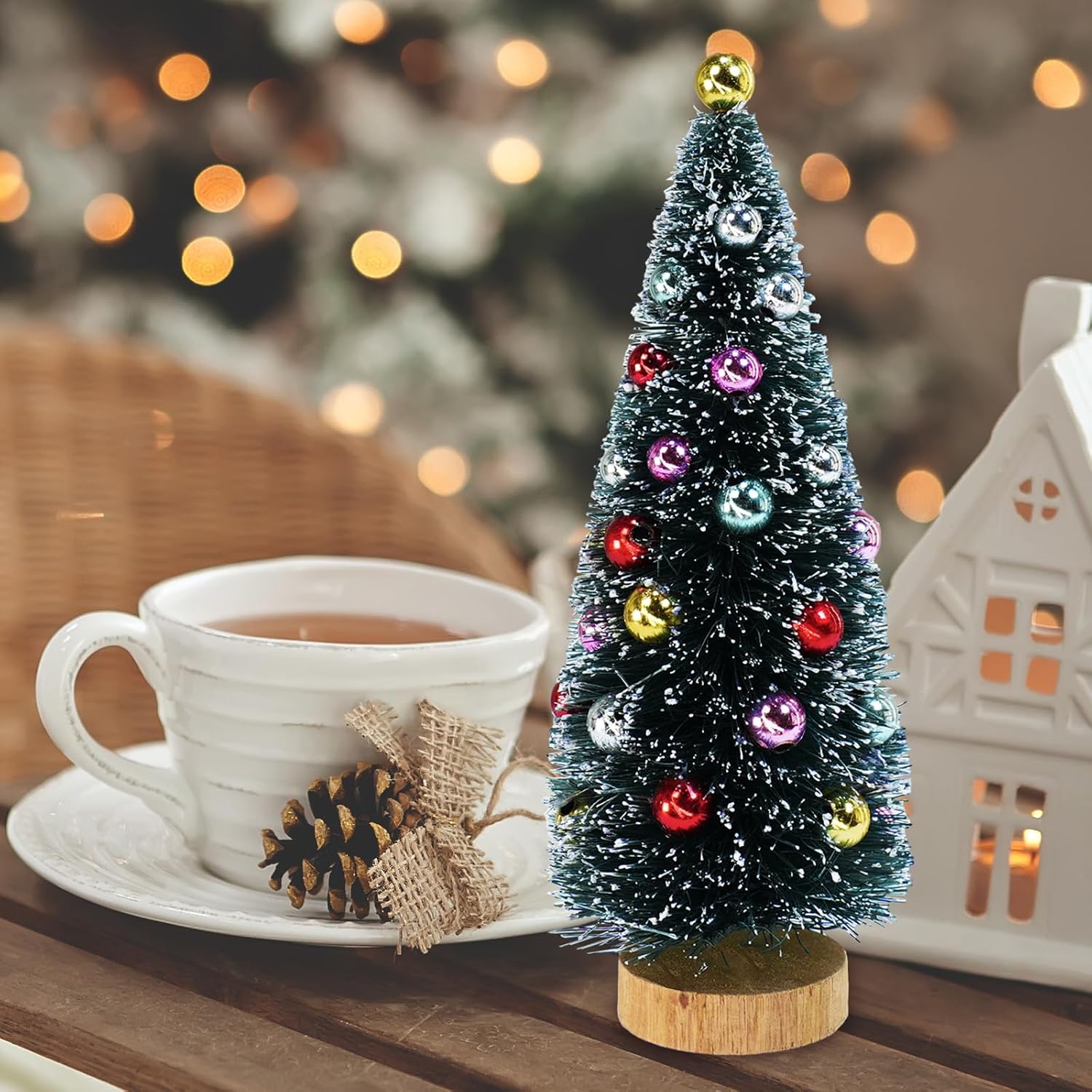 A Winlyn miniature tree beside a cup in a listing scene