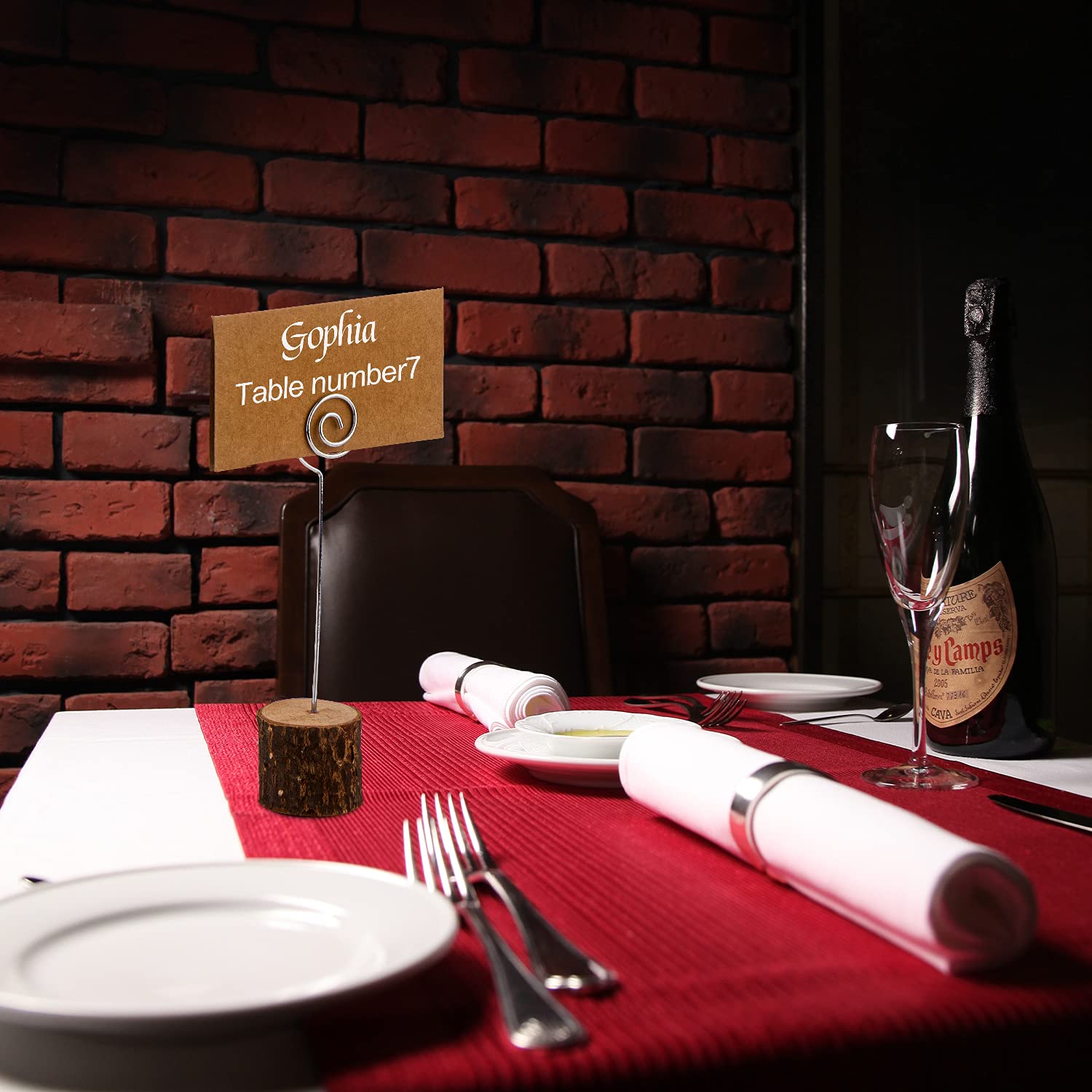 Wooden wire holder with a place card beside dining props