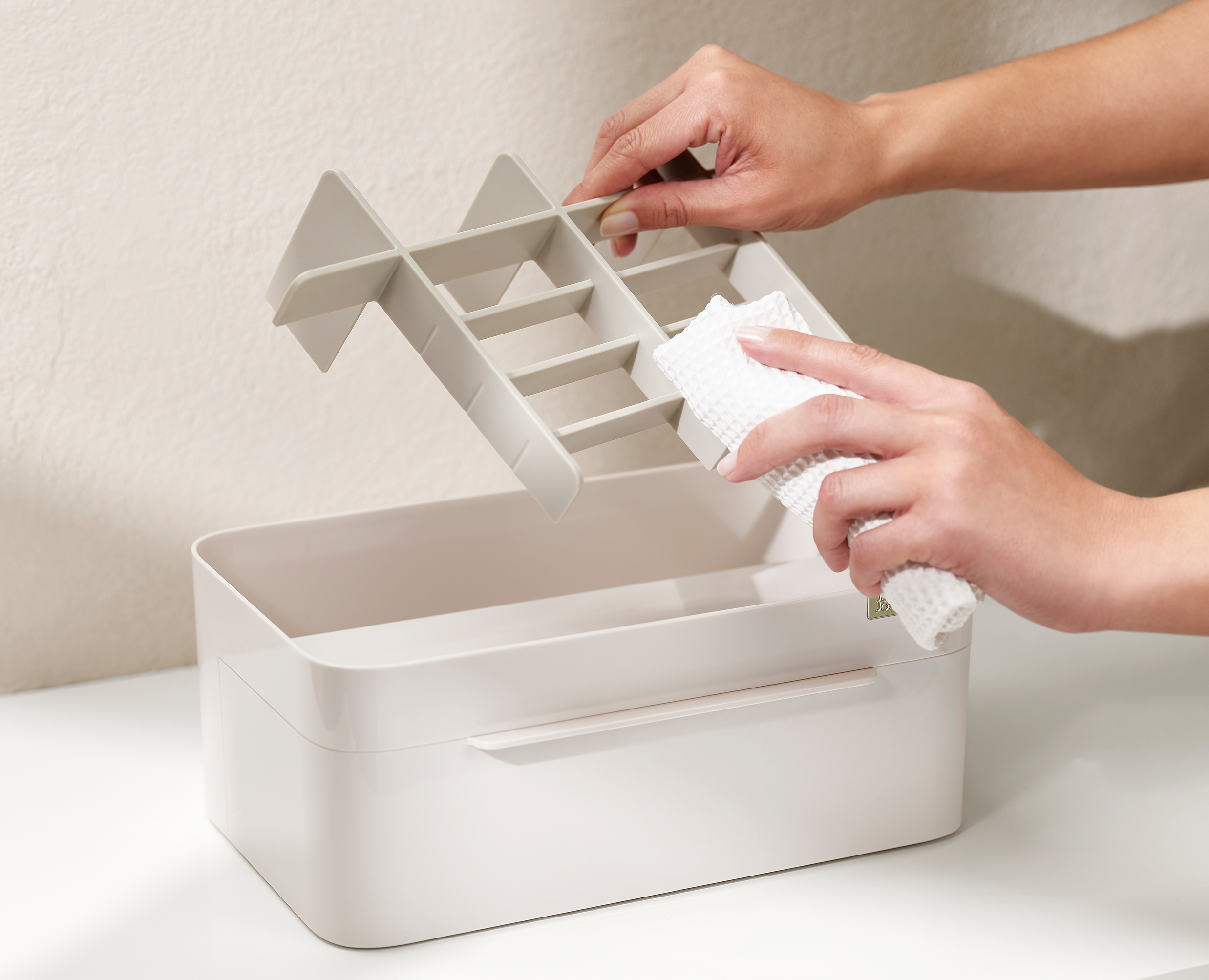 Removed Viva compartment insert being wiped with a cloth