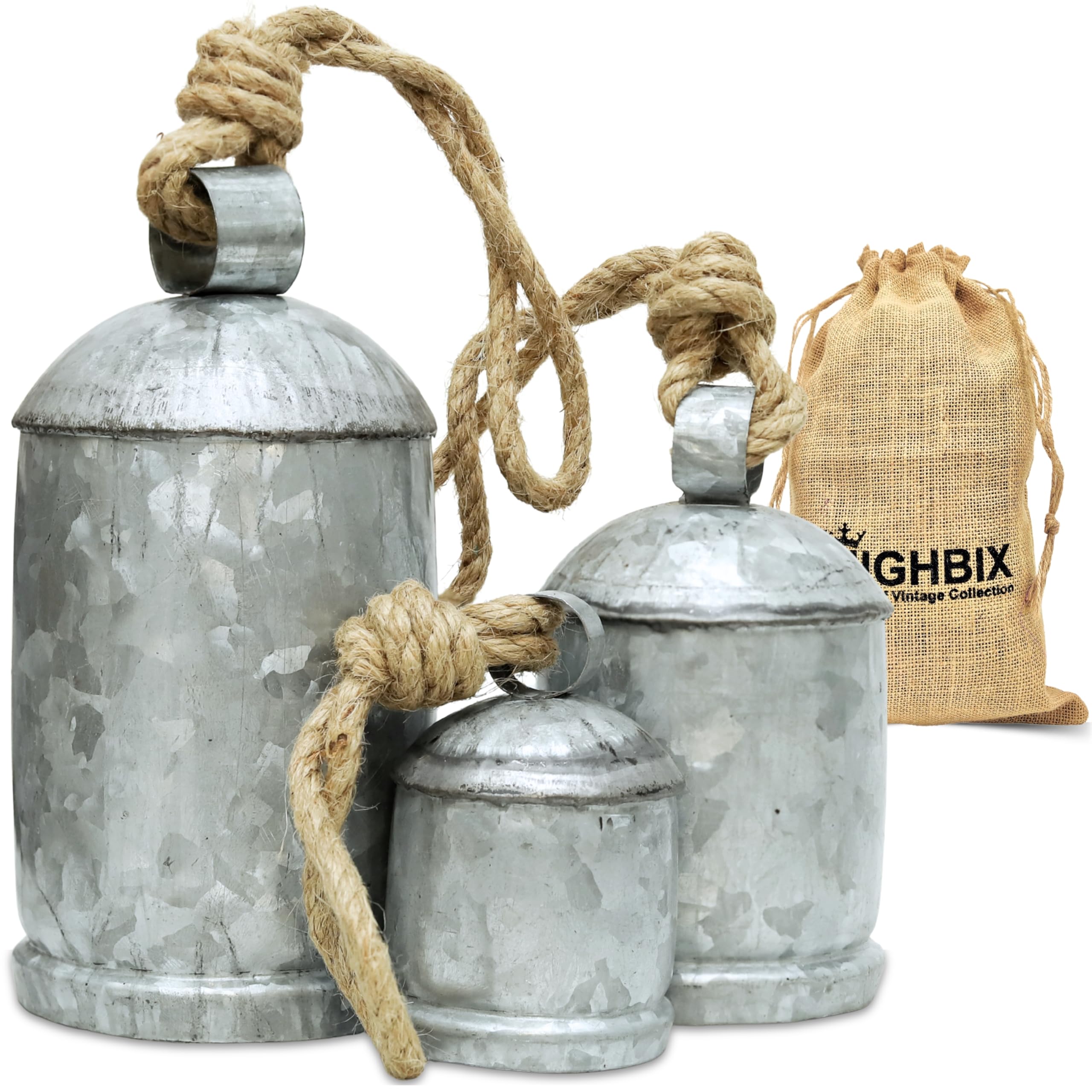 Three galvanized metal bells with jute cords and packaging props