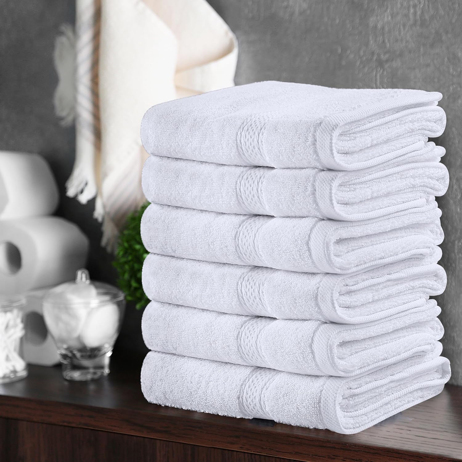 White Utopia hand towels stacked in a supplier bathroom scene