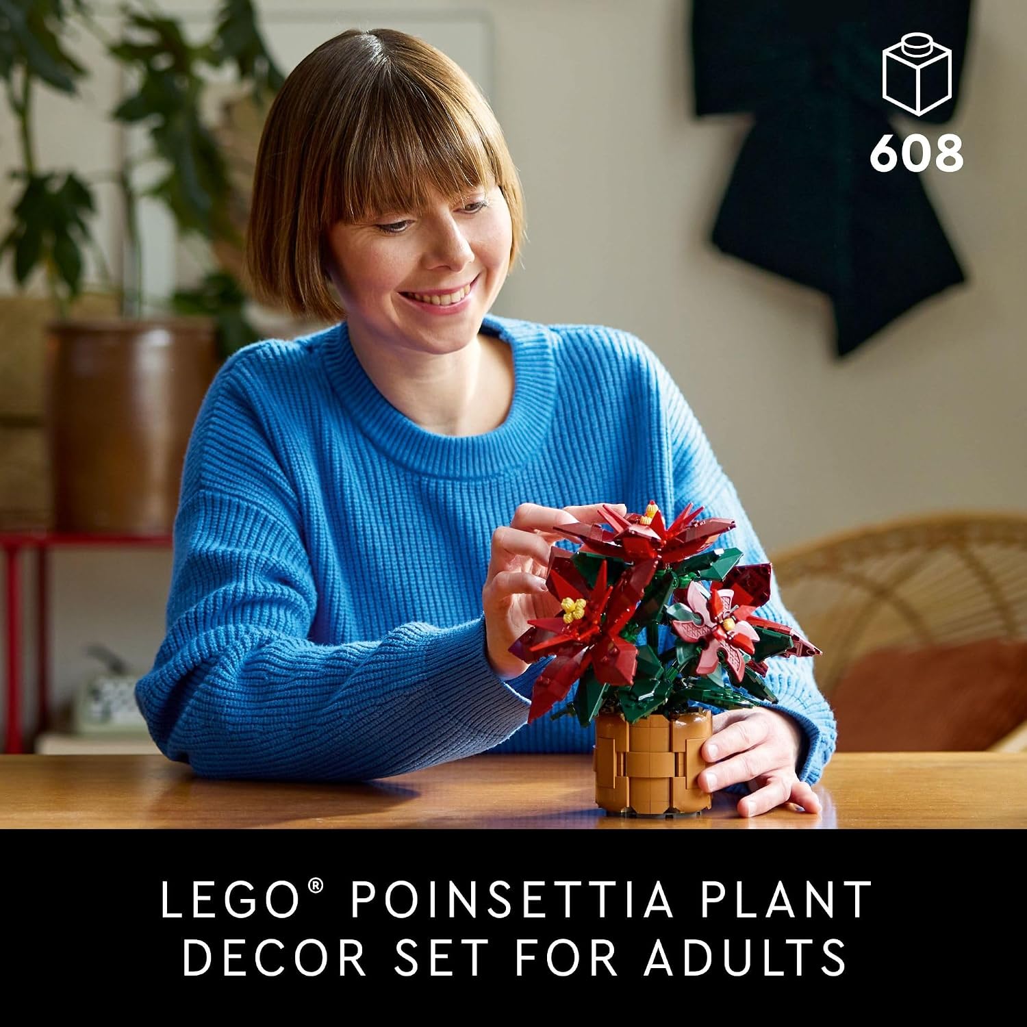 Adult building the LEGO Poinsettia model in a supplier scene