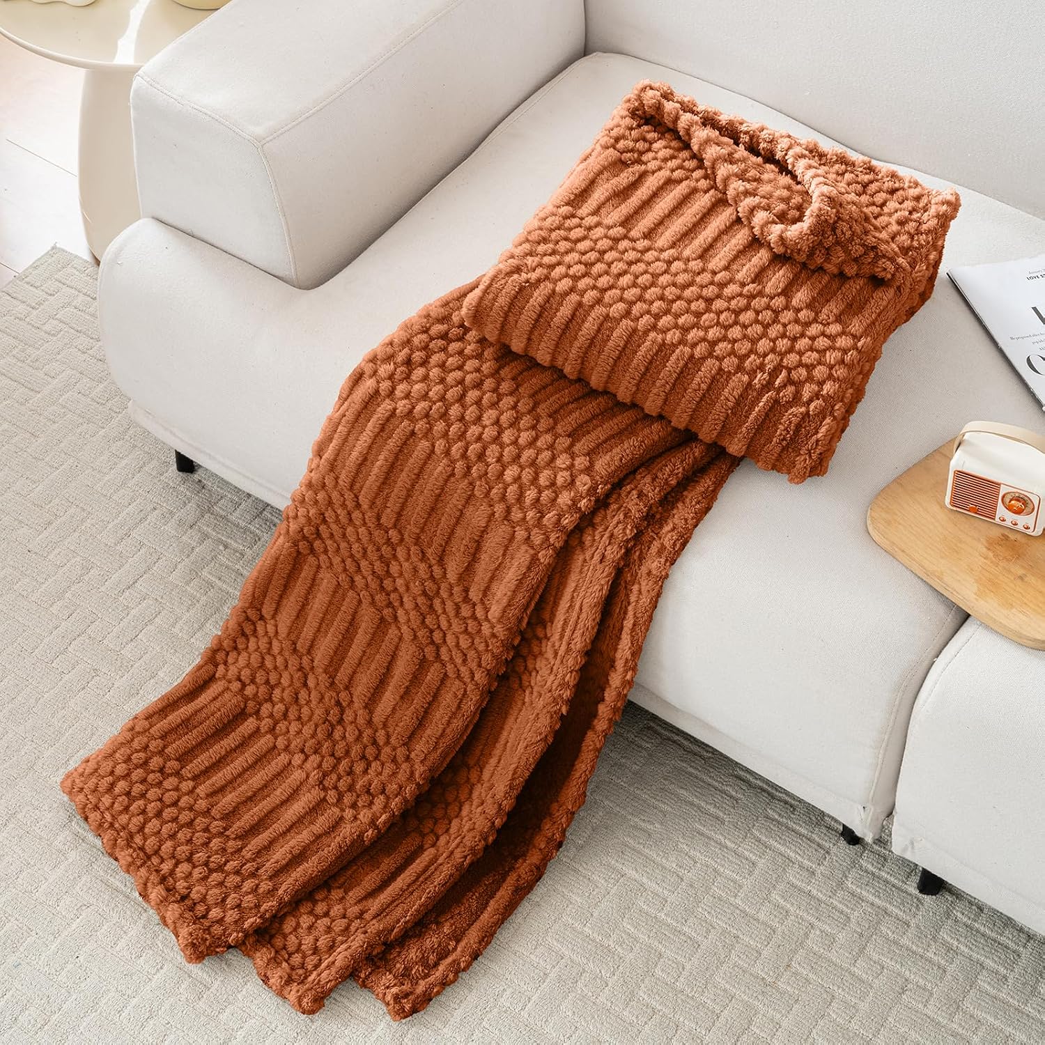 Rust throw spread over a chair in a promotional scene