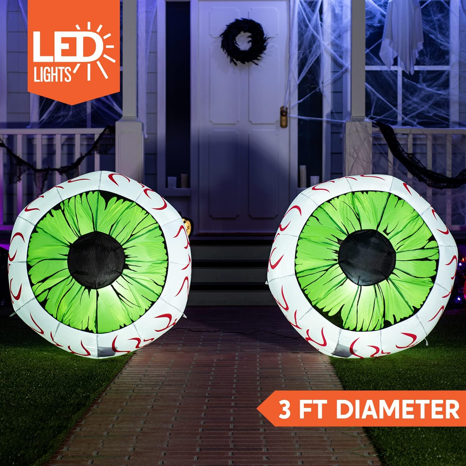 Two illuminated green eyes beside a styled entrance