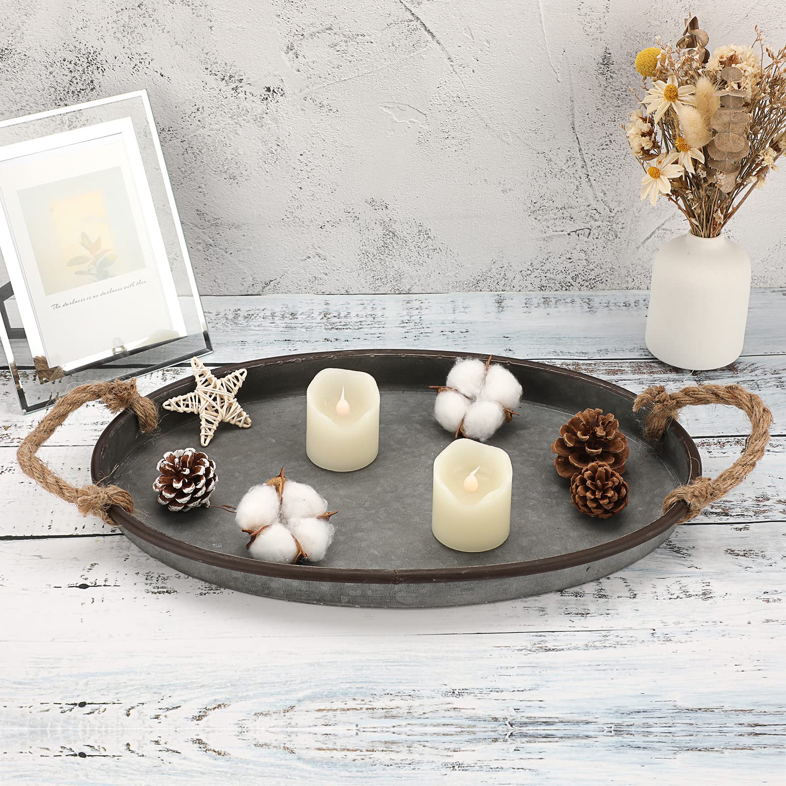 Hipiwe oval metal tray grouping separate lights and pine cones on a table