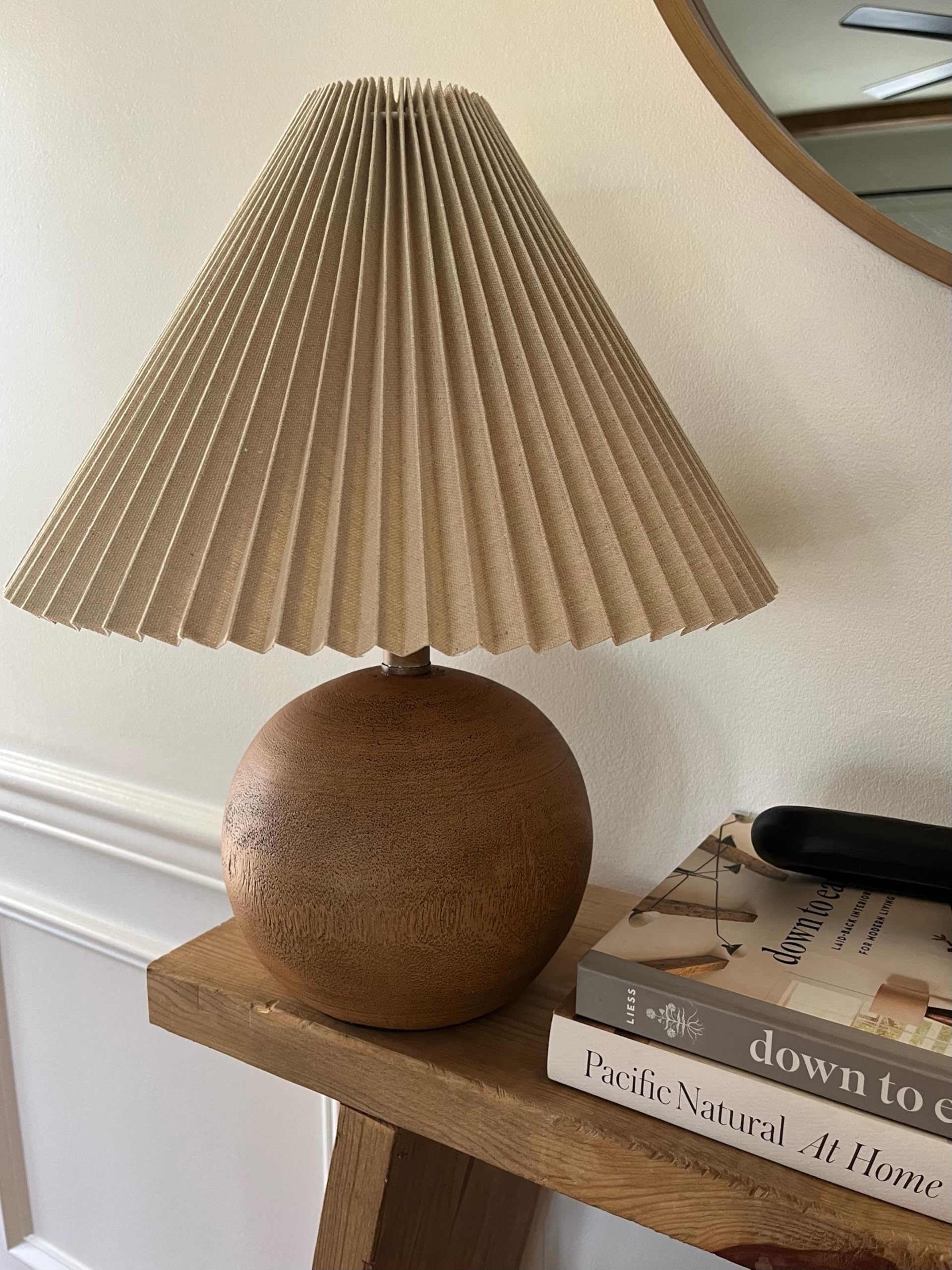 Aksel table lamp positioned on a bedside surface in a supplier scene