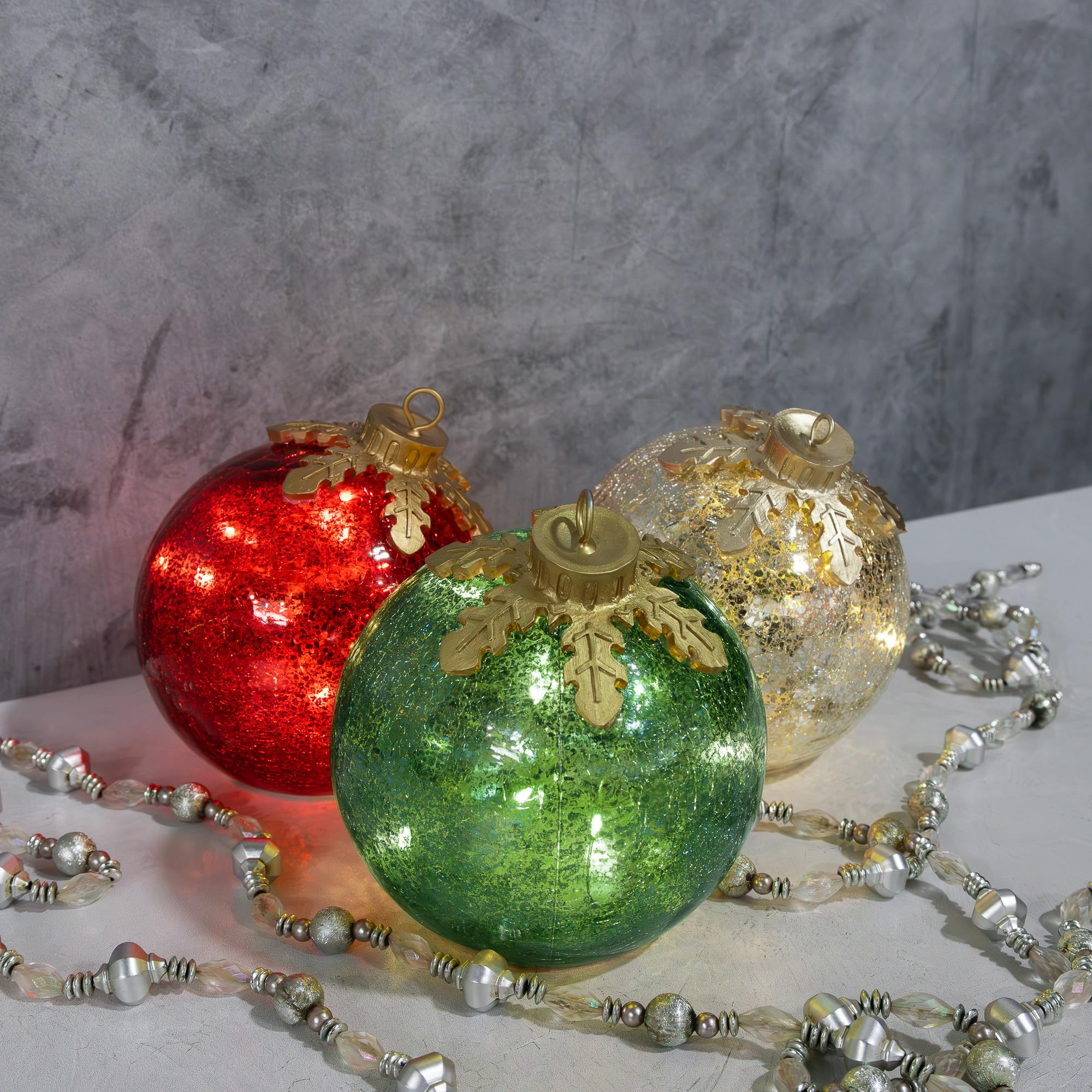 Lighted LumaBase globes styled with separate metallic garland