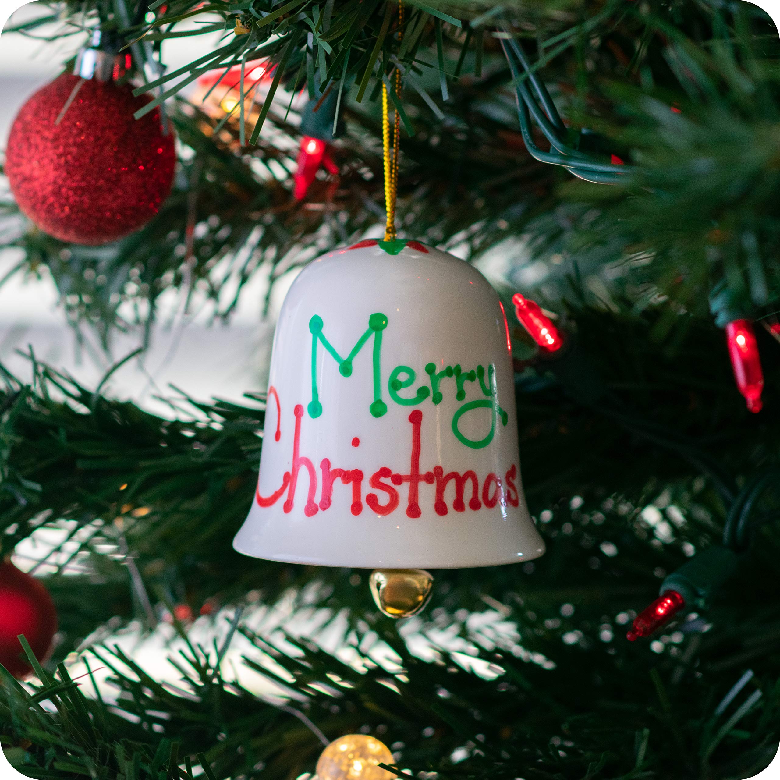 Decorated porcelain bell hanging on a Christmas tree