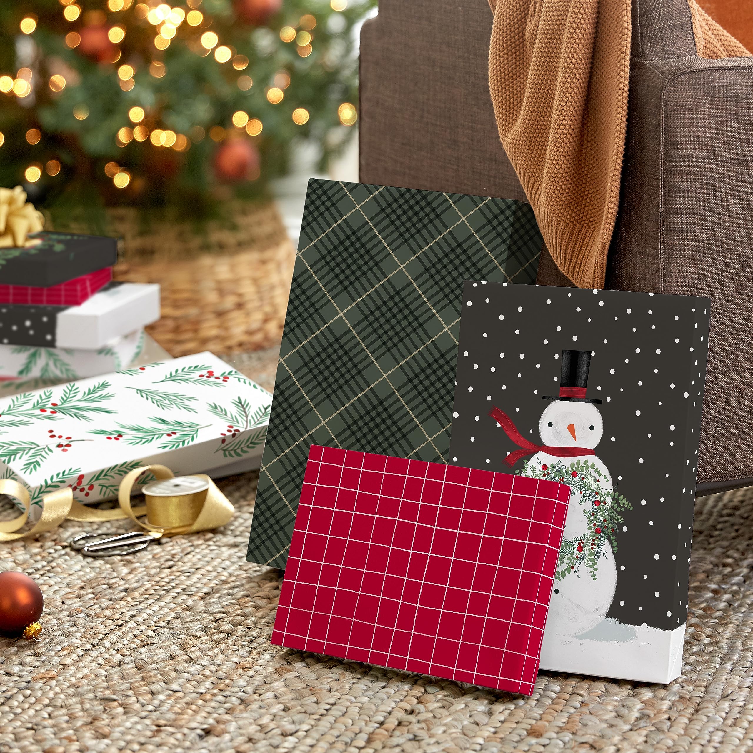 Hallmark Christmas shirt boxes styled beside folded clothing and wrapping supplies