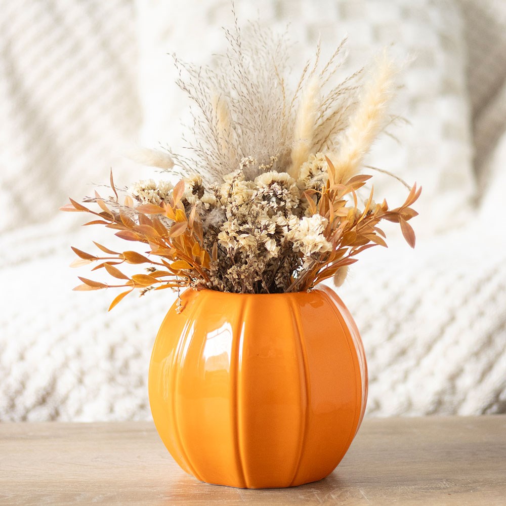 Selected orange pumpkin vase with a stem arrangement